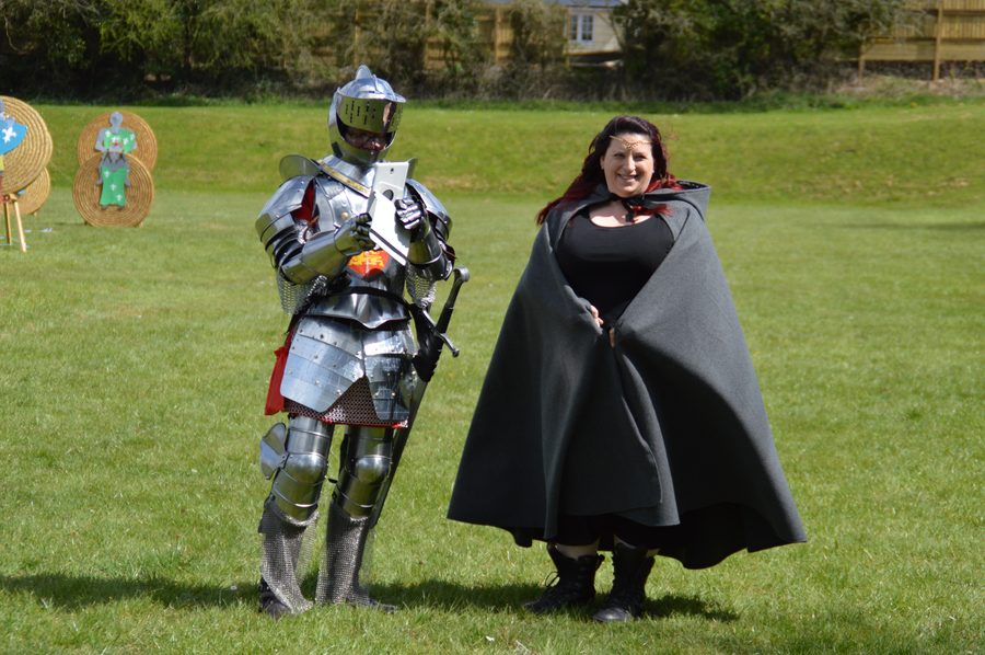 Two costumed people on an archery field with novelty targets behind them
