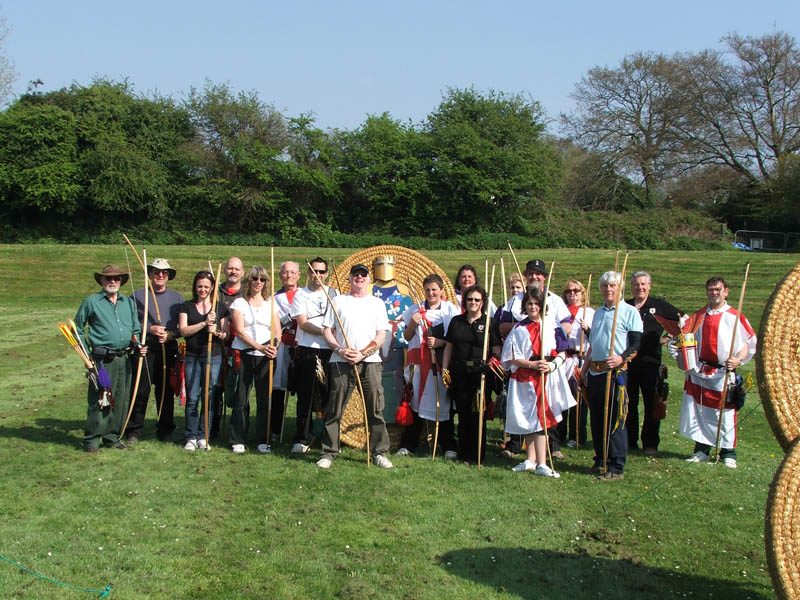 Archers gathered with bows in front of traditional straw targets