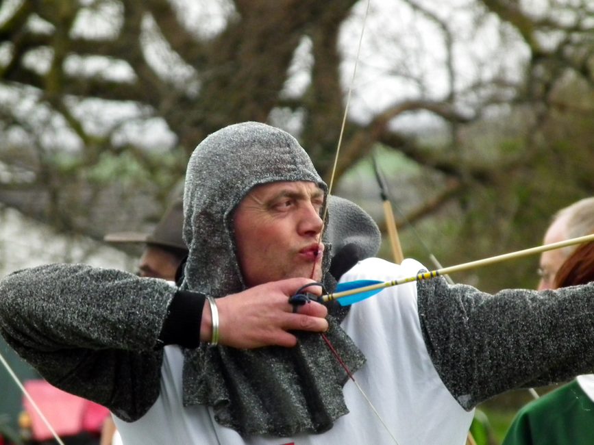 Close view of a longbow archer at full draw